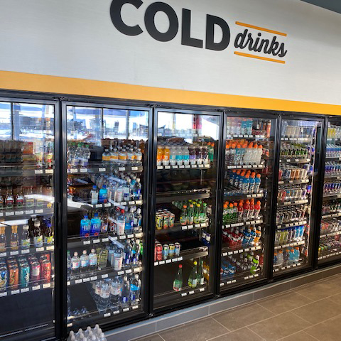 Convenience store cooler filled with drinks that was installed by Rapid Refrigeration