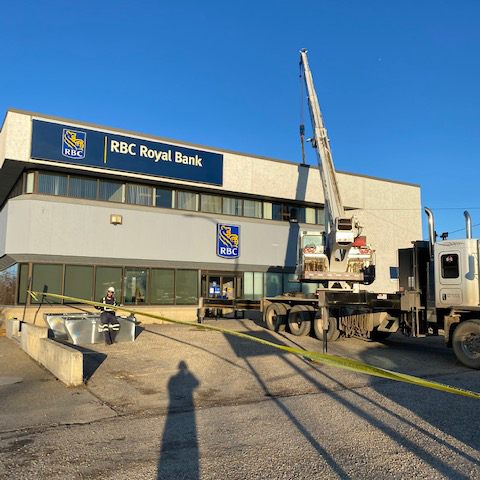 Crane lifting HVAC equipment on to an RBC Bank building in Dawson Creek